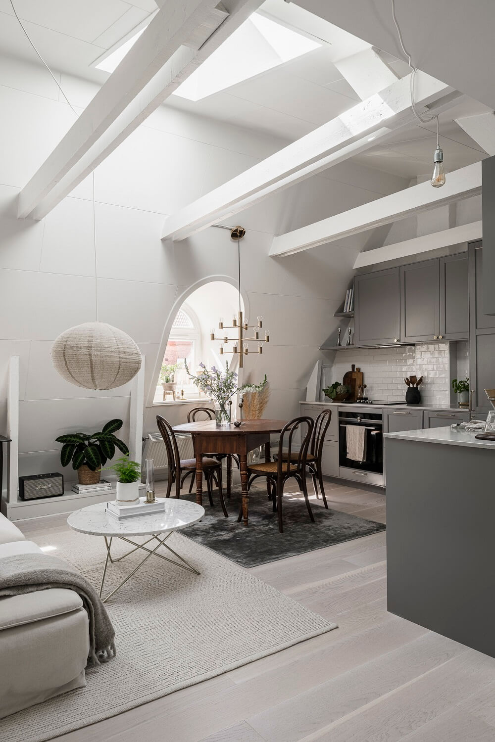 attic living room high pitched ceiling skylight gray kitchen nordroom