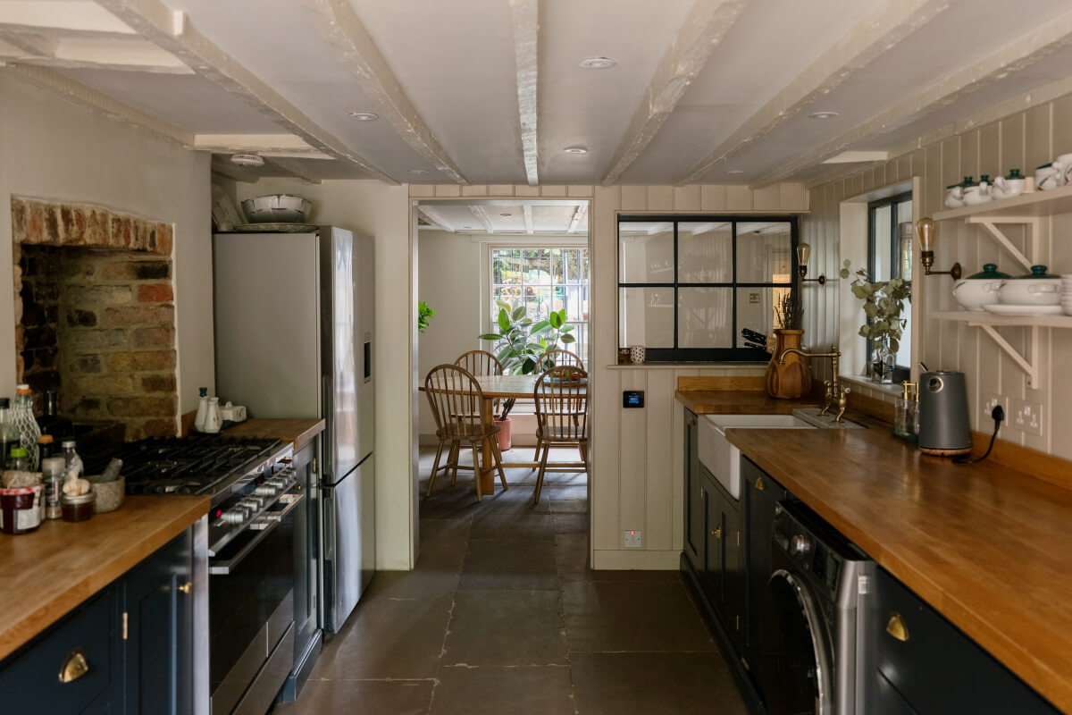 A Classic Georgian House in London with a Lush Garden 15 basement kitchen dark blue cupboards wooden countertop