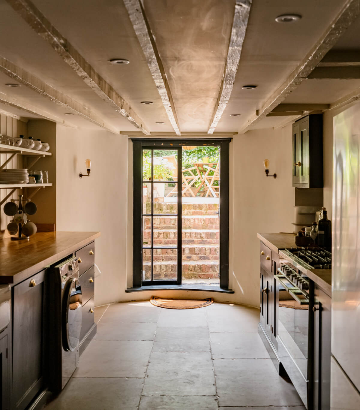 A Classic Georgian House in London with a Lush Garden 11 basement kitchen stone floor garden doors