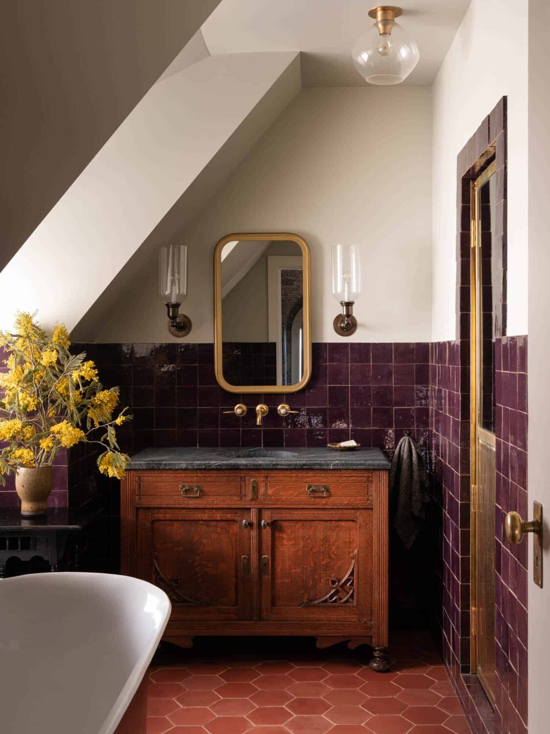 40+ Colorful Bathrooms That Will Spruce Up Your Home 3 bathroom-antique-sanity-soapstone-sink-purple-tiles-hexagon-terracotta-floor-tiles-slanted-ceiling-nordroom