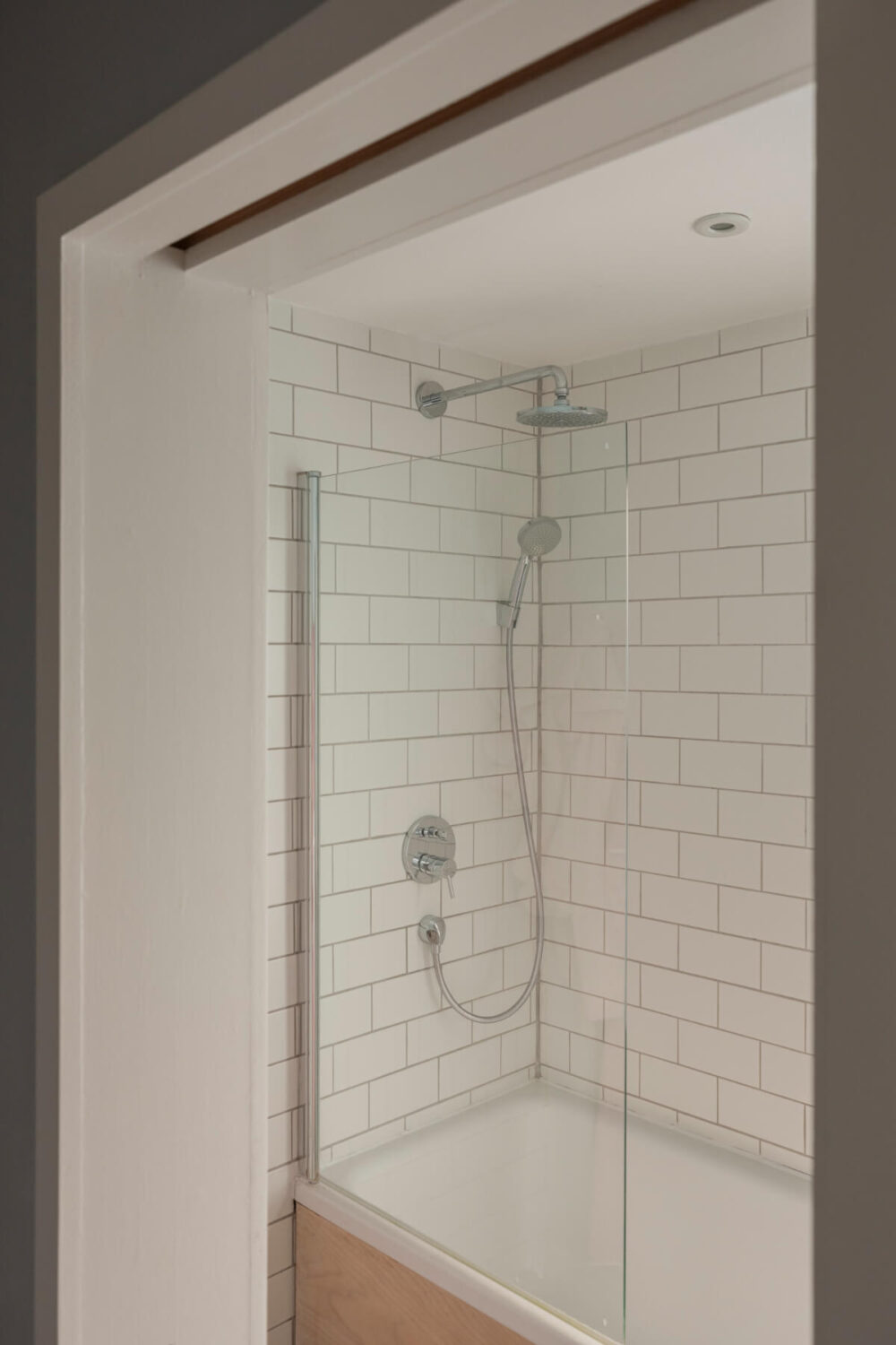 Exposed Brick and Wooden Beams in an Extended London Home 30 bathroom combined shower bath white tiles