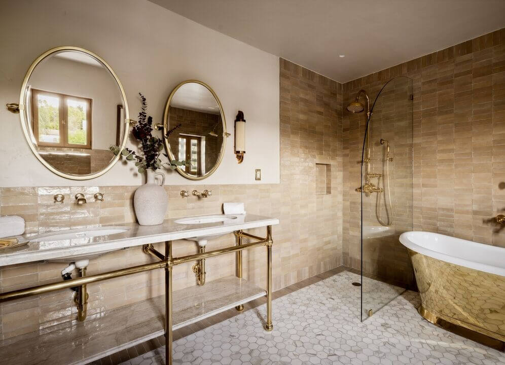 A Reimagined Spanish Colonial Revival Estate in Los Angeles 13 bathroom double shower and sinks gold tub