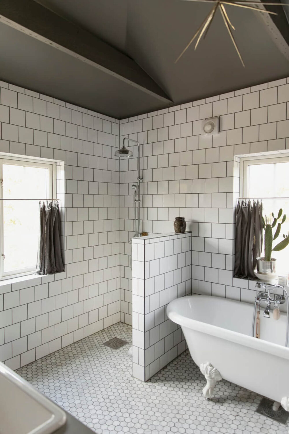 An Open-Plan Gray Home in a Former Textile Factory 16 bathroom freestanding bath white tiles gray ceiling nordroom