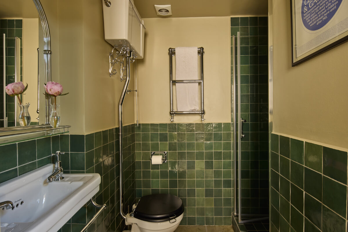 A 19th Century London Cottage with a Stunning Kitchen Extension 25 bathroom green tiles beige walls