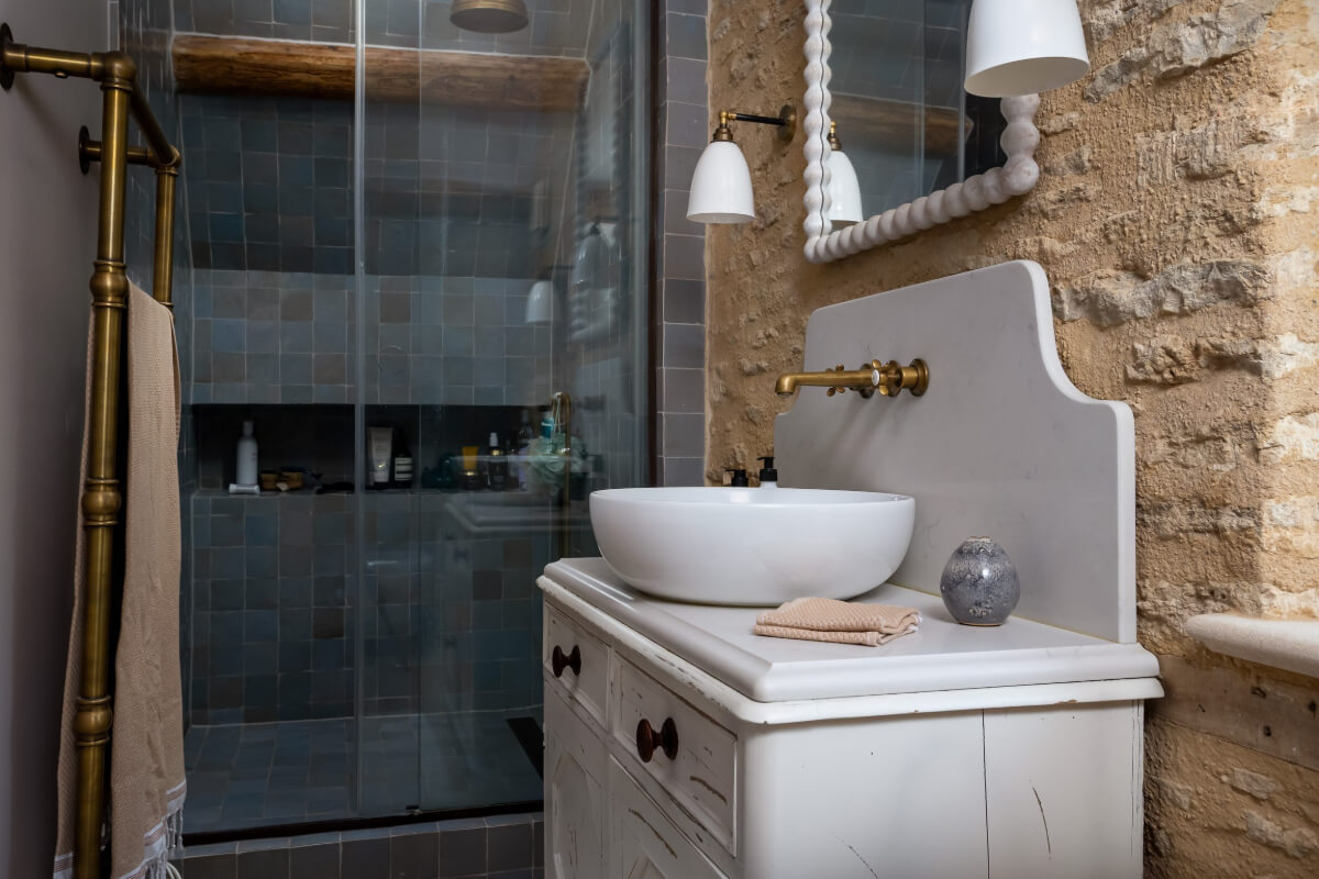 A Charming Cotswold Cottage with a deVOL Kitchen 15 bathroom stone wall blue shower tiles