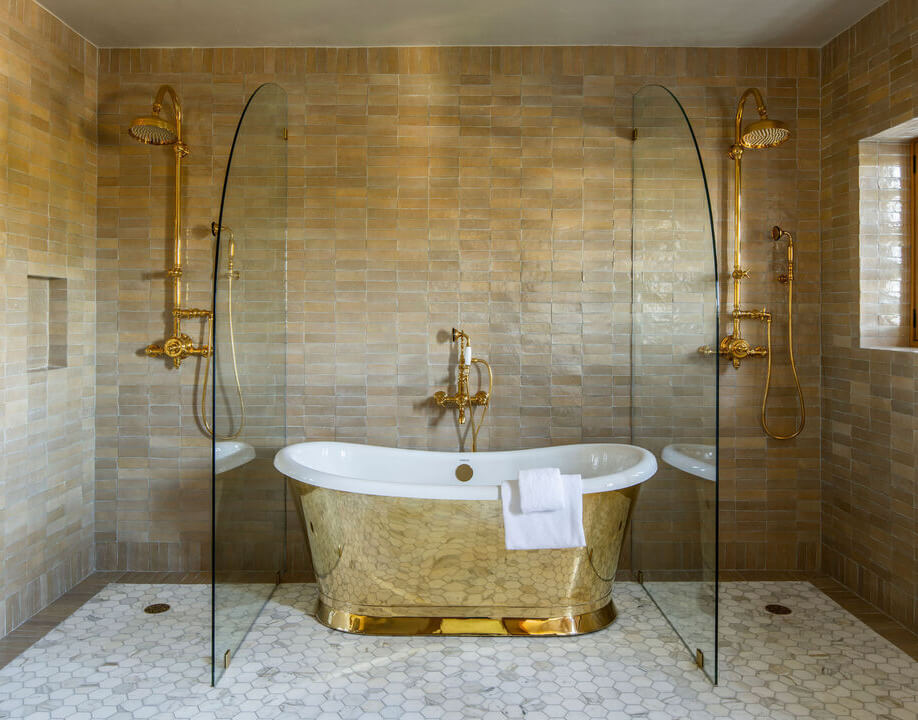 A Reimagined Spanish Colonial Revival Estate in Los Angeles 12 bathroom with gold tub