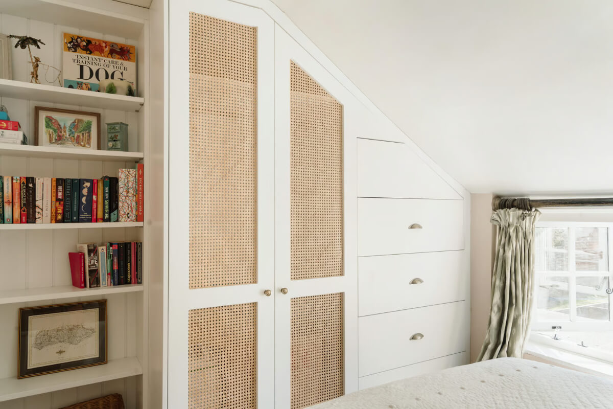A Historic English Cottage Decorated in Pink & Blue Tones 15 bedroom built-in wardrobes under slanted ceiling