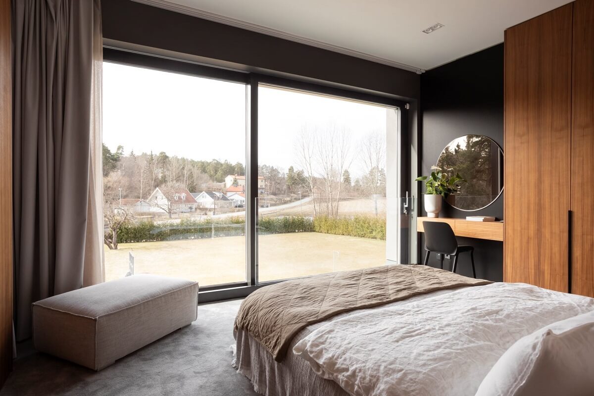 A Luxurious Architect-Designed Villa in Sweden 15 bedroom with black walls and wooden wardrobes