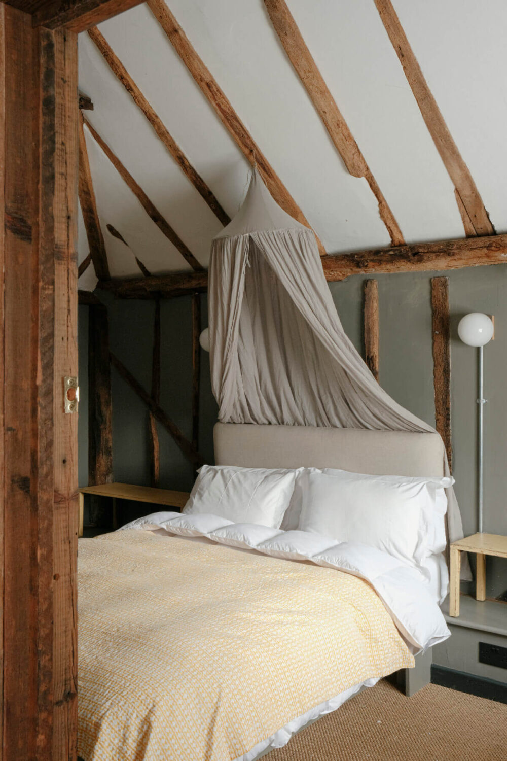 A Barn House with Vintage Decor and Exposed Beams 35 bedroom with canopy and pitched ceiling with wooden beams