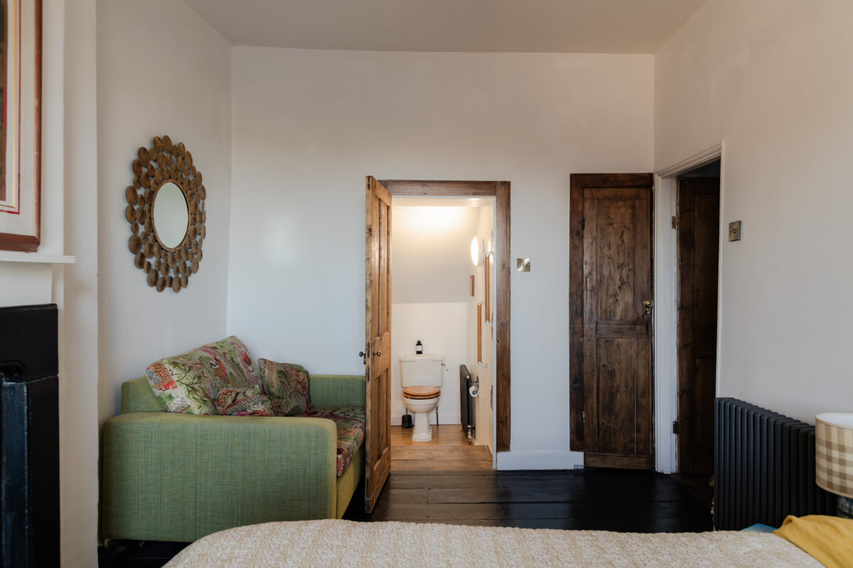 A Georgian English House Restored To Its Former Glory 21 bedroom with green couch