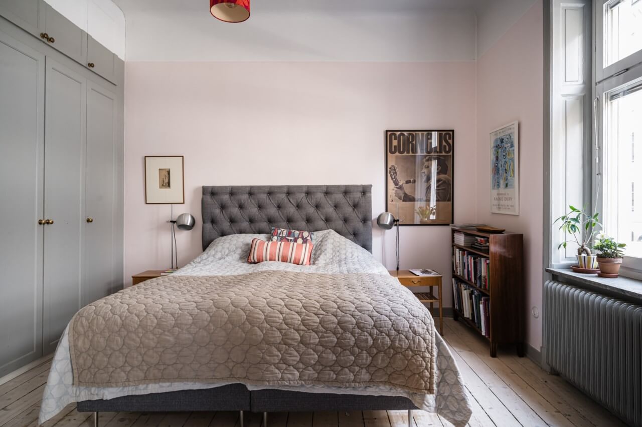 bedroom with light pink wall and built in wardrobes