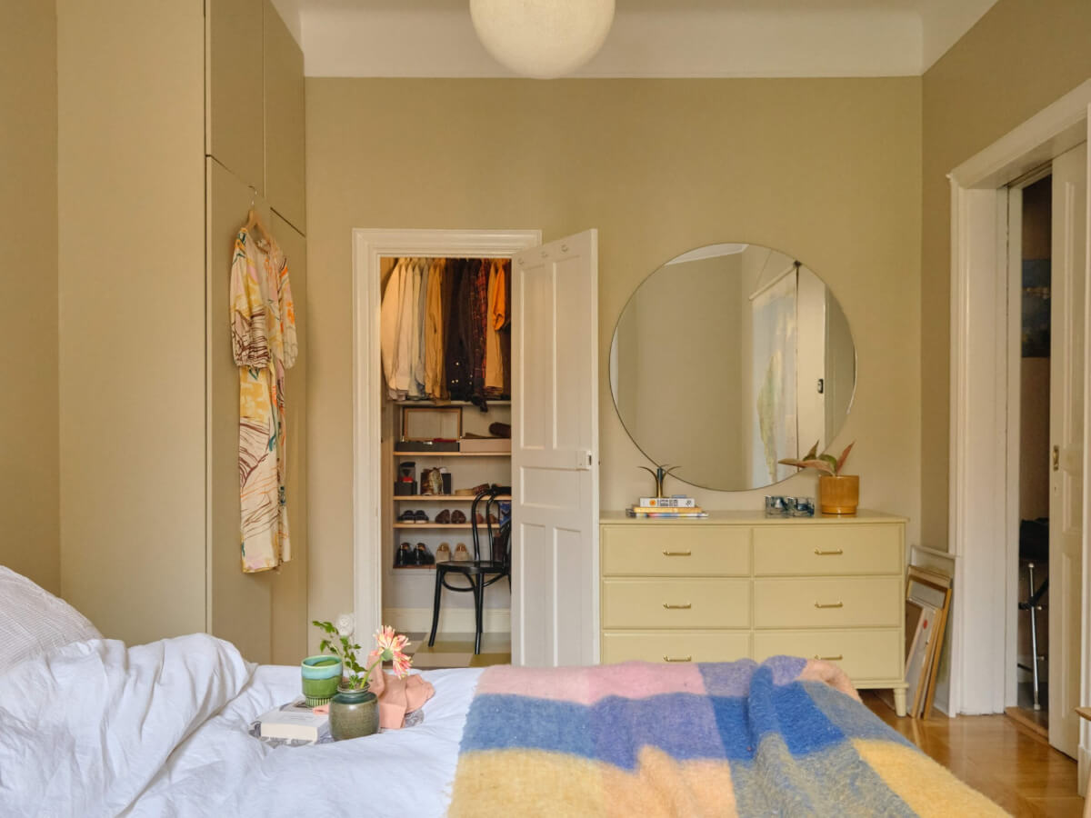 A Beautiful Color Palette and Historic Elements in a Stockholm Apartment 23 beige bedroom built-in wardrobe