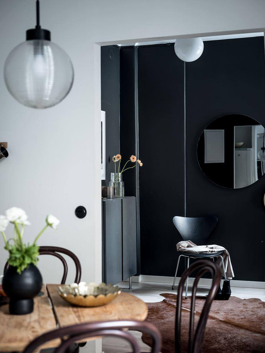 A Cozy Monochrome Gray Studio Apartment 19 black feature wall hallway studio apartment
