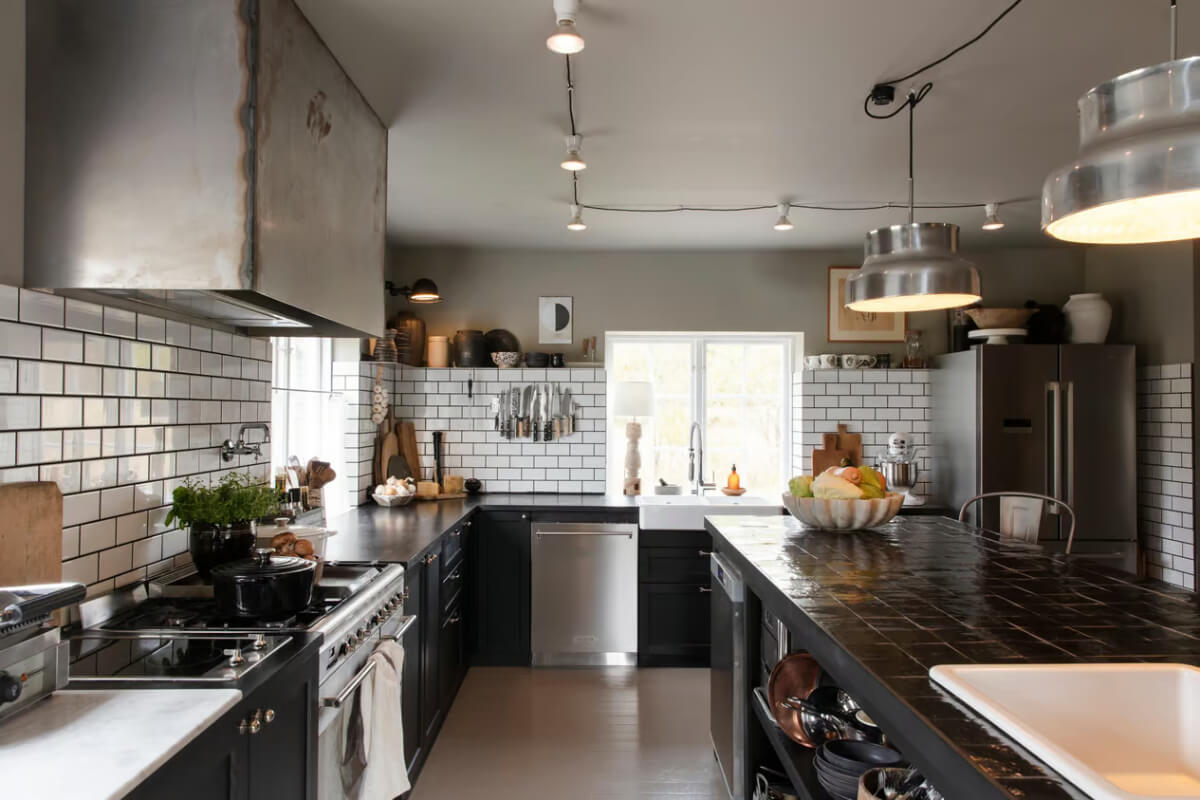 An Open-Plan Gray Home in a Former Textile Factory 7 black kitchen white tiles gray ceiling