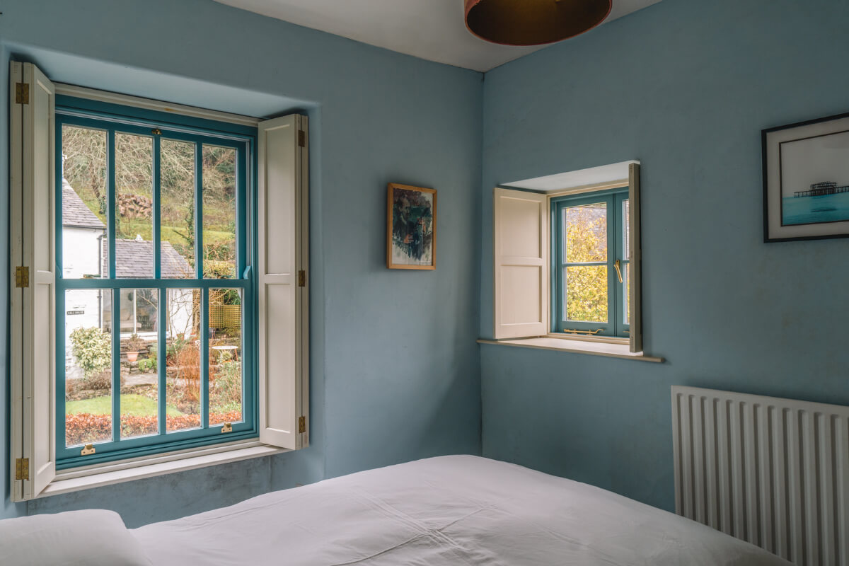 A Colorful 19th-Century Cottage in the Lake District 14 blue bedroom with blue window frames
