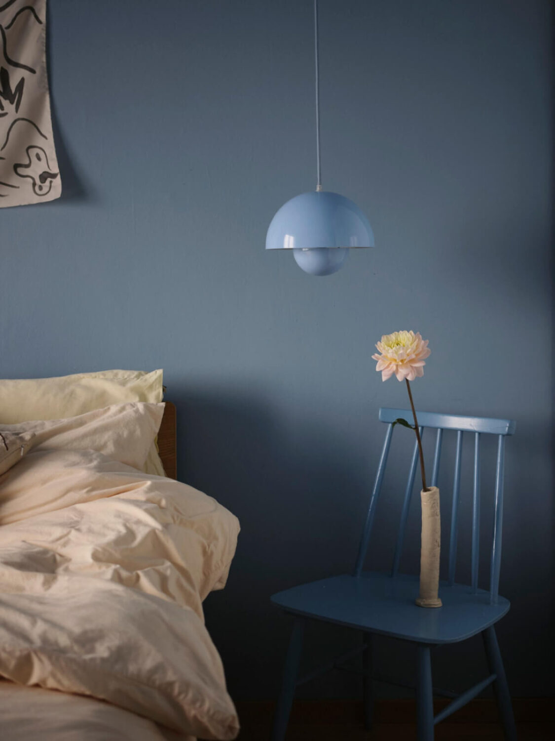 A 1940s Swedish Apartment with a Soft Yellow Kitchen 17 blue chair and pendant