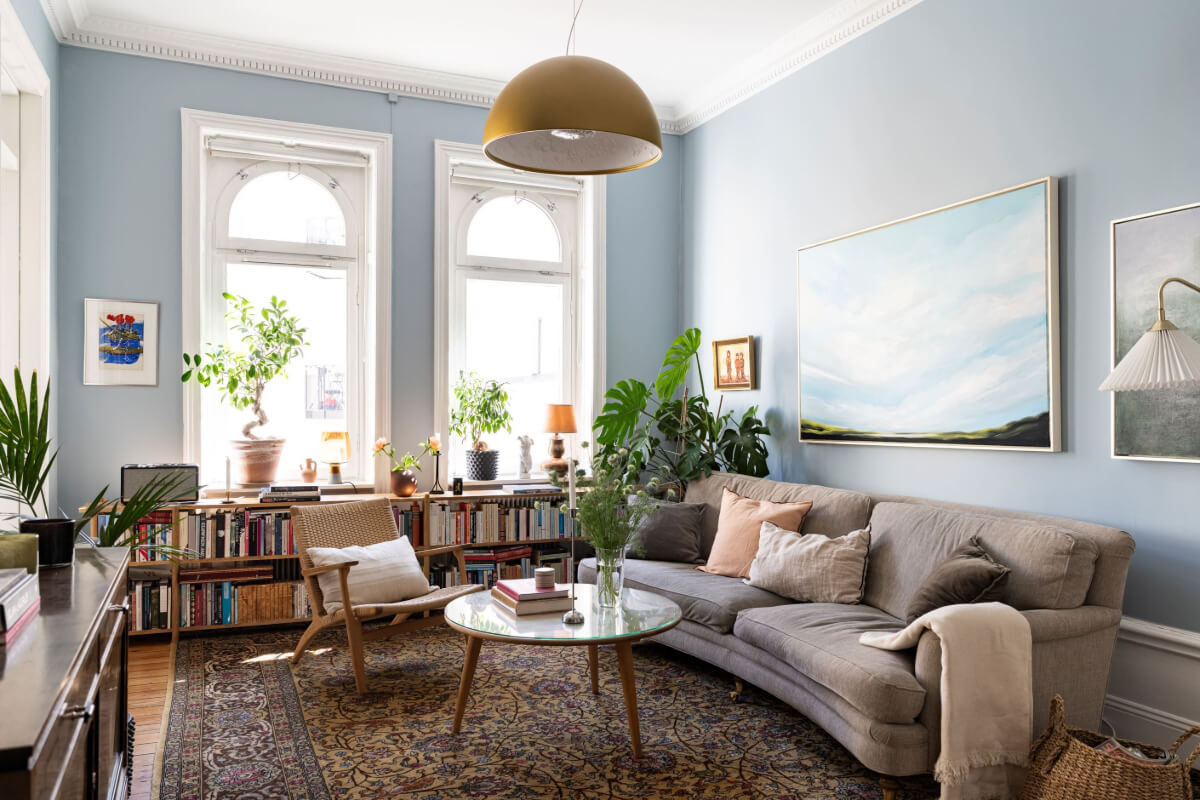 blue living room bookcases under windows