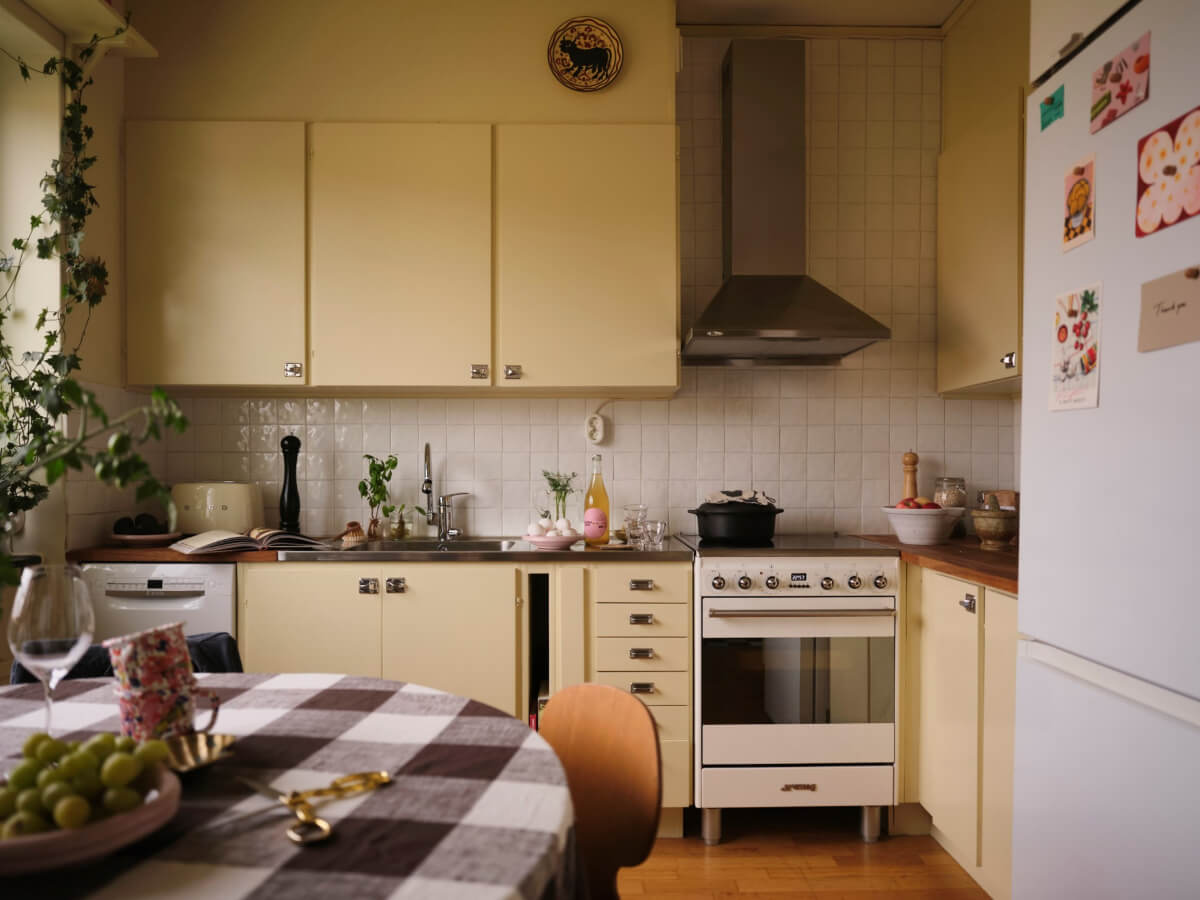A 1940s Swedish Apartment with a Soft Yellow Kitchen 10 blue midcentury kitchen cabinets