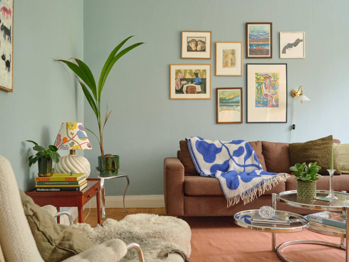 A Beautiful Color Palette and Historic Elements in a Stockholm Apartment 1 blue paint small gallery wall