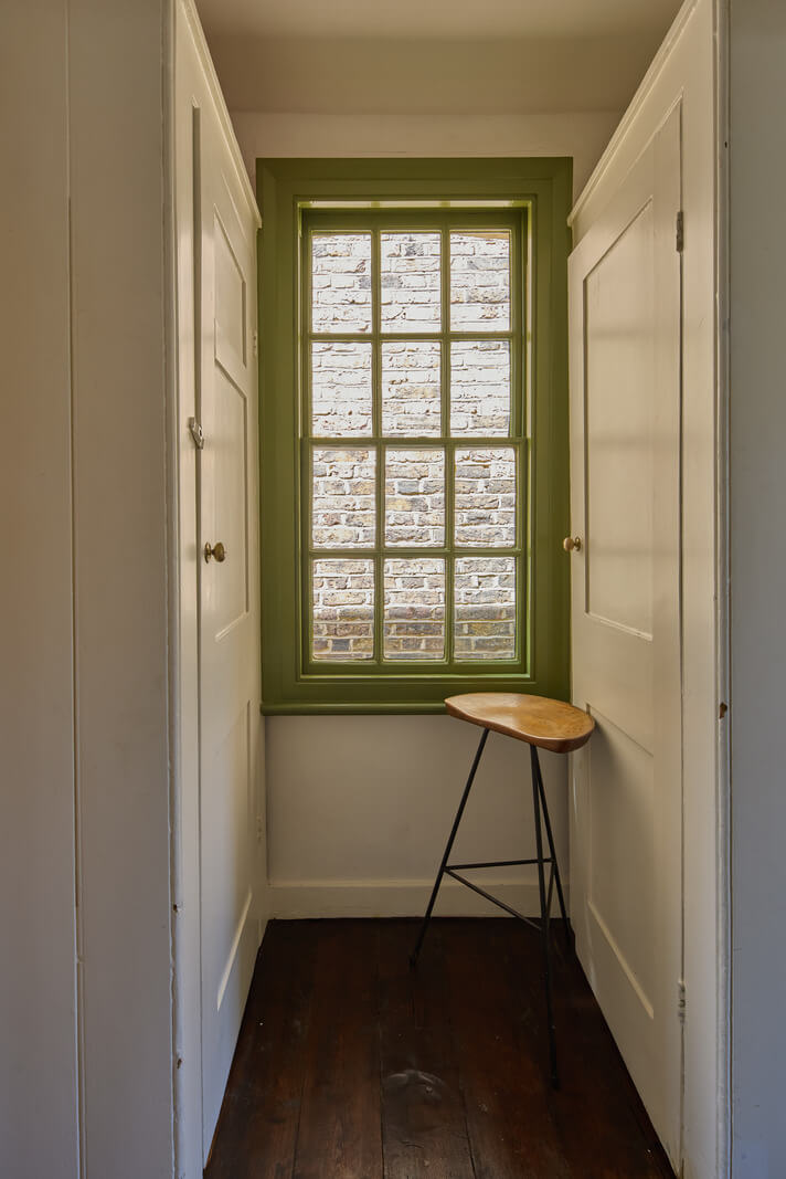 A 19th Century London Cottage with a Stunning Kitchen Extension 15 built-in wardrobes green windowframe