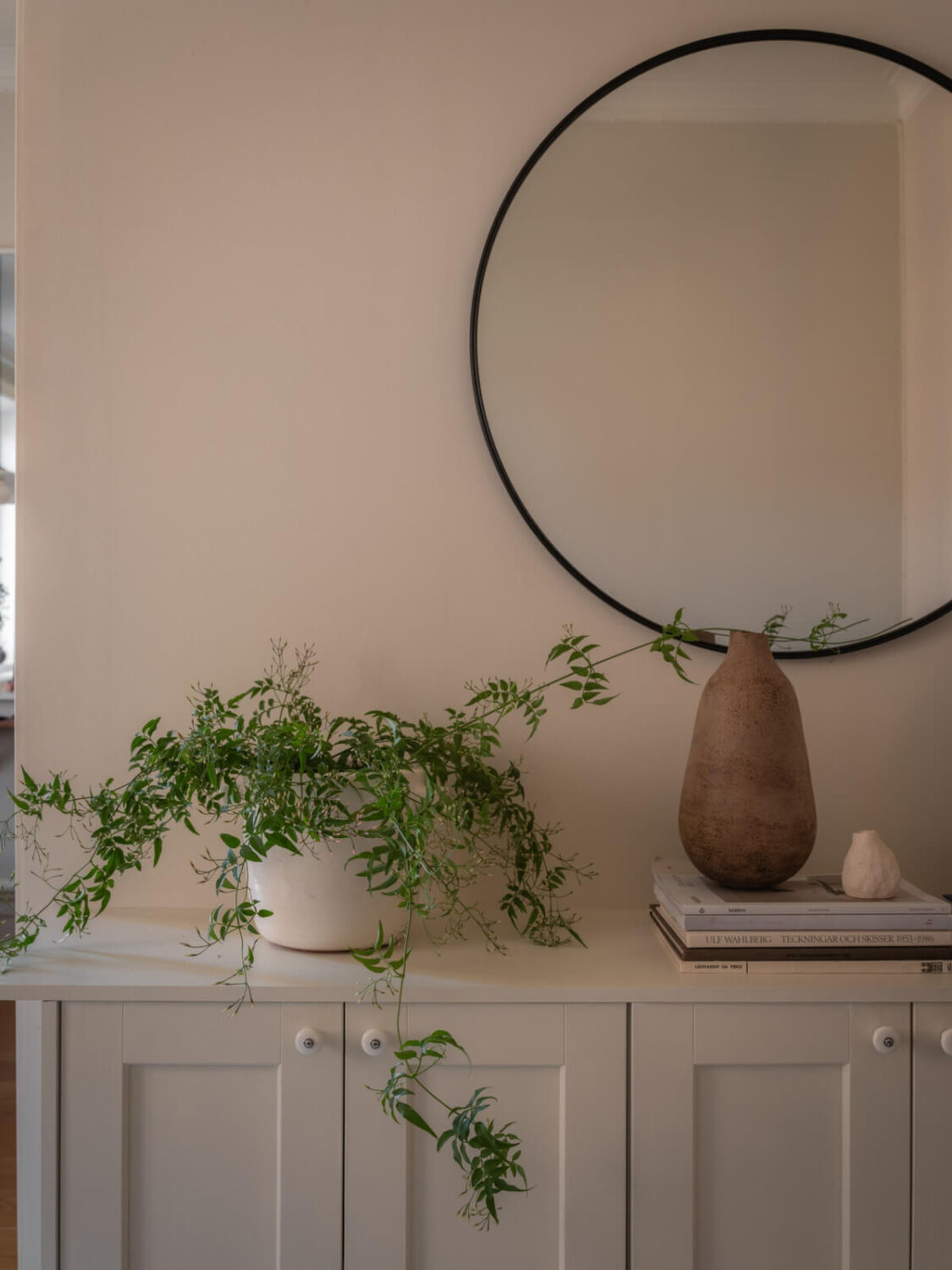 A 19th Century Apartment with a Dark Glass Room Divider 7 cabinets round mirror
