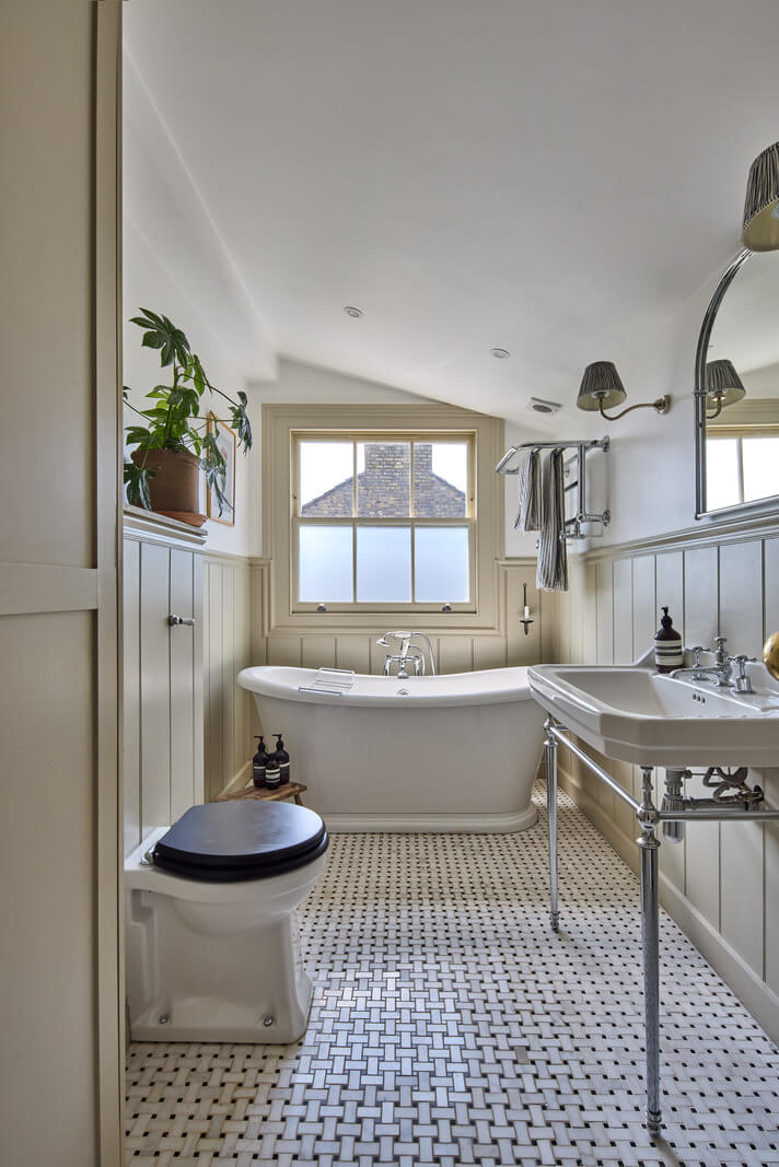 A 19th Century London Cottage with a Stunning Kitchen Extension 21 classic bathroom pitched ceiling wall paneling freestanding bath
