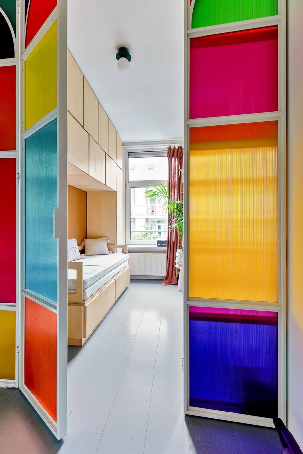 An Amsterdam Apartment with Surprising Bold Color Accents 15 colorful glass doors bedroom