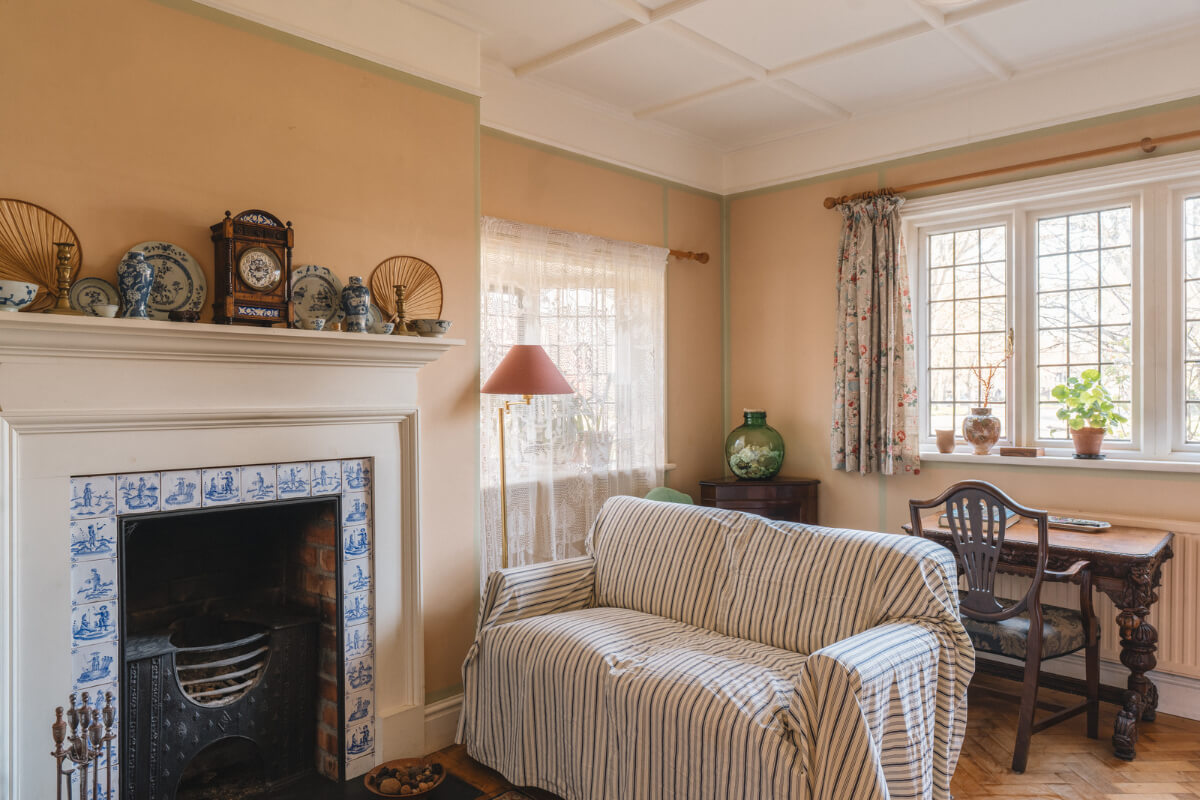 A Sage Green Kitchen in a Charming Arts and Crafts House 2 cottage style living room delft blue tiles fireplace