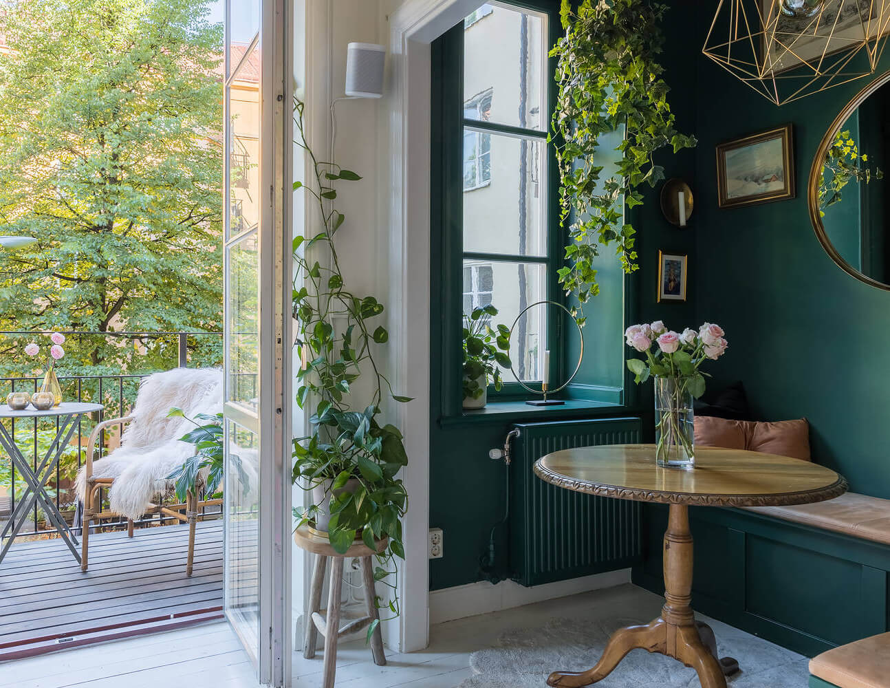 Behr Color of the Year 2026: Hidden Gem 23 cozy breakfast nook with round wooden table and plants nordroom Behr Color of the Year 2026: Hidden Gem