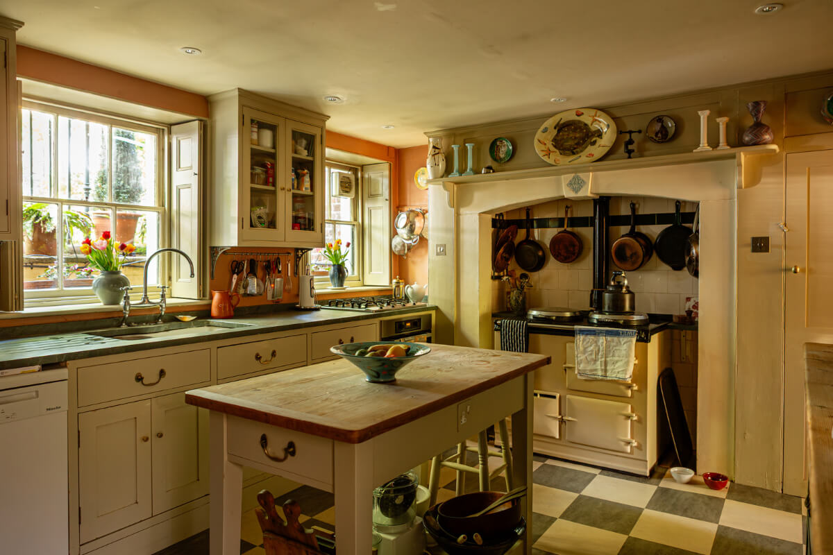 cozy country-style kitchen checkerboard floor aga stove