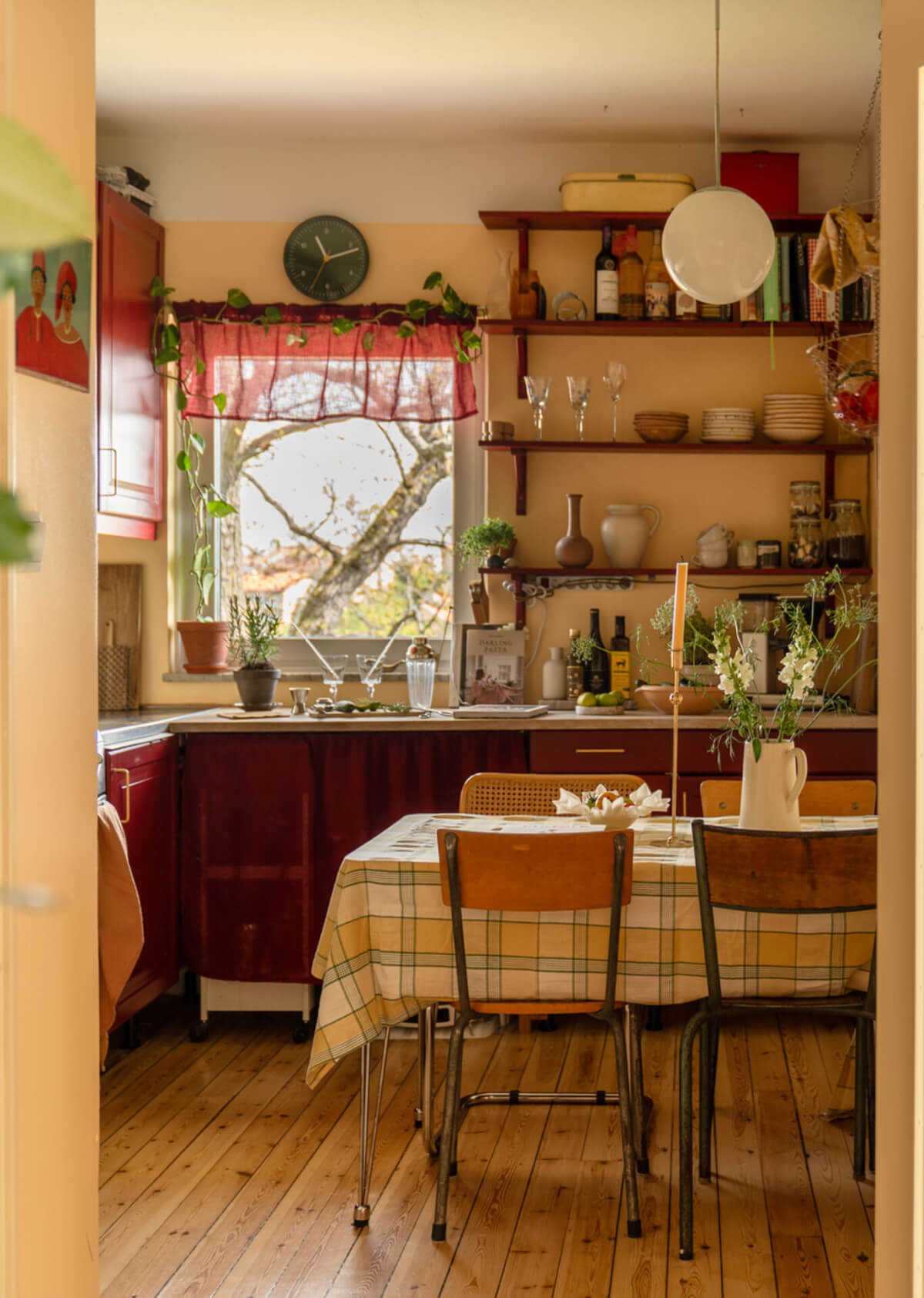 cozy kitchen wooden floor deep red cabinets yellow walls shelves nordroom