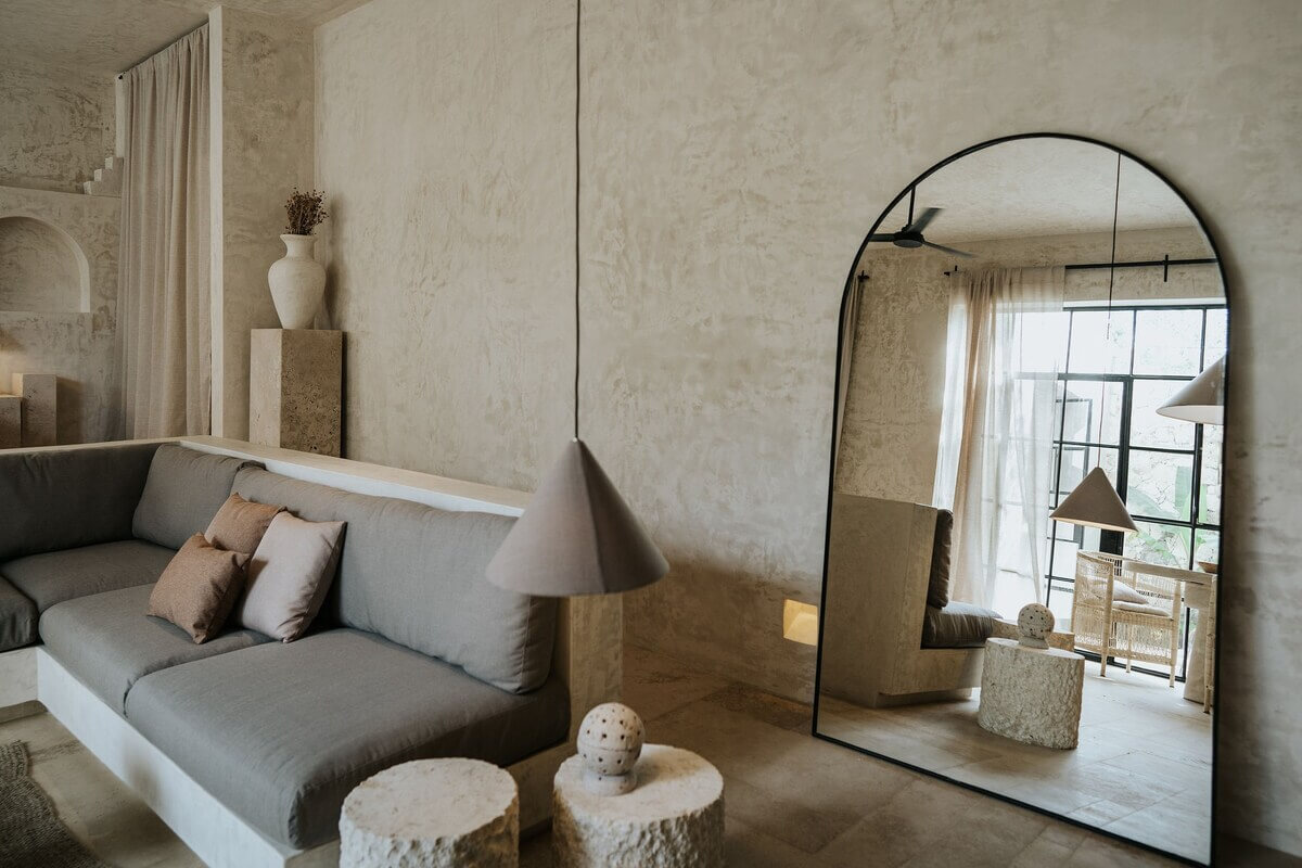 A Serene Design Apartment in Tulum 4 large arched mirror living room airbnb apartment mexico