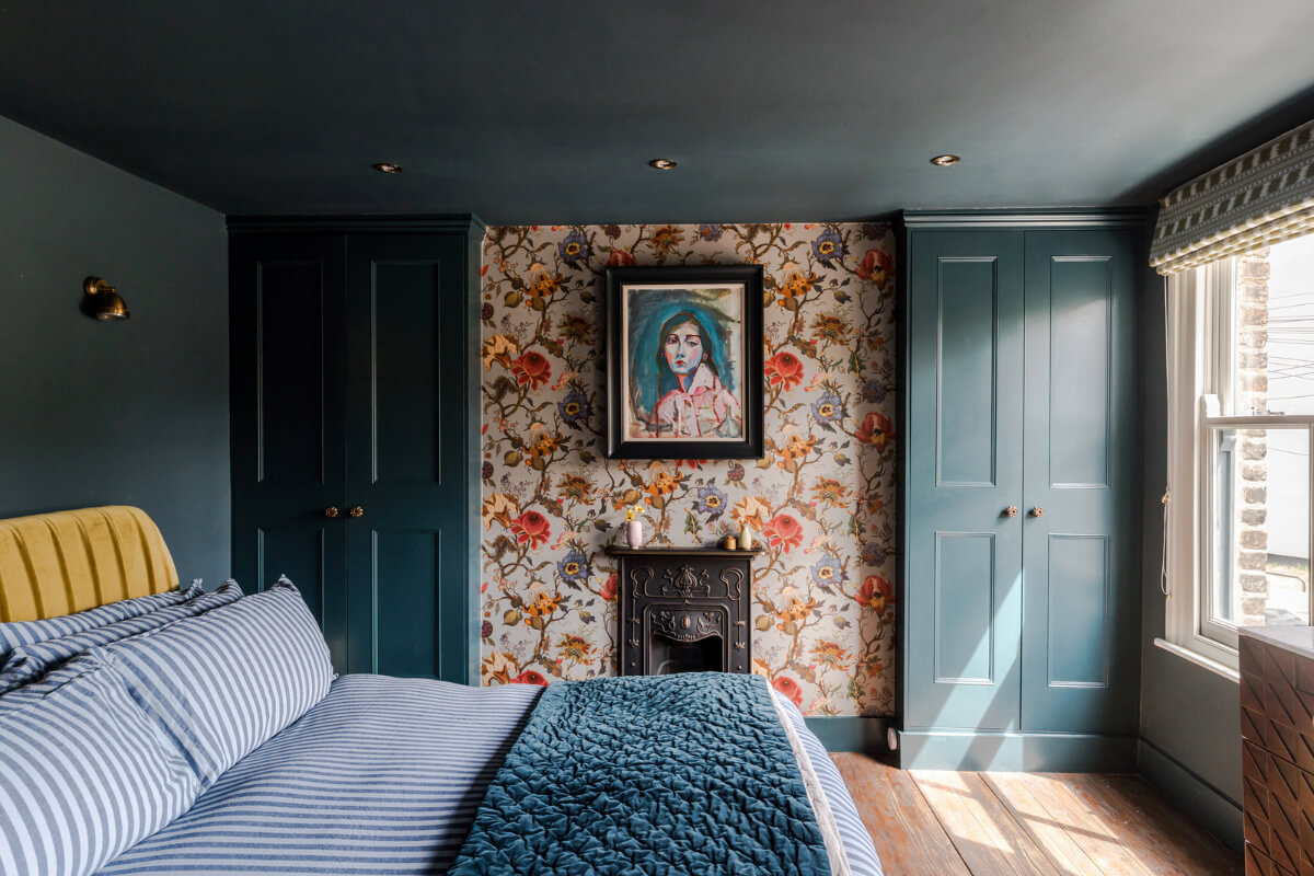 A Victorian Home with a Rich Color Palette and a Beautiful Garden 16 dark blue bedroom striped bedding floral wallpaper