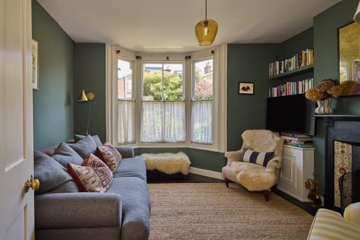 A 19th Century London Cottage with a Stunning Kitchen Extension 1 dark blue sitting room bay window