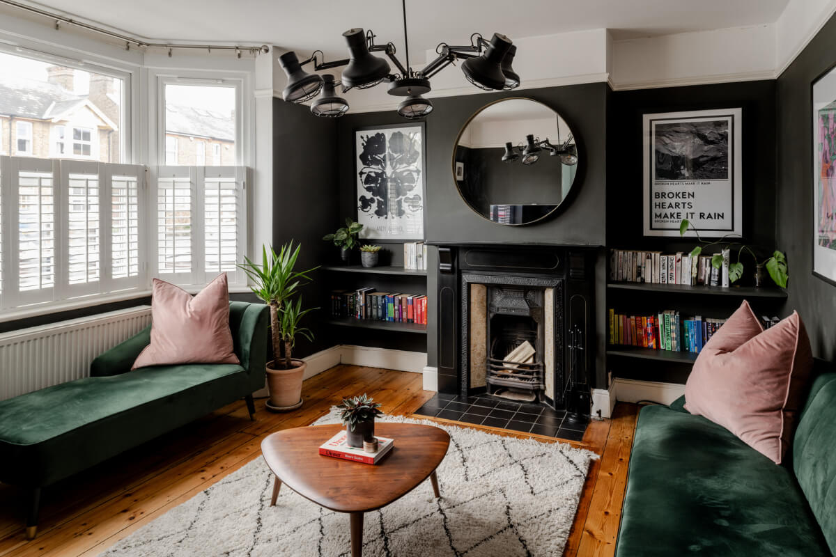 dark gray living room bay window green velvet sofas and fireplace