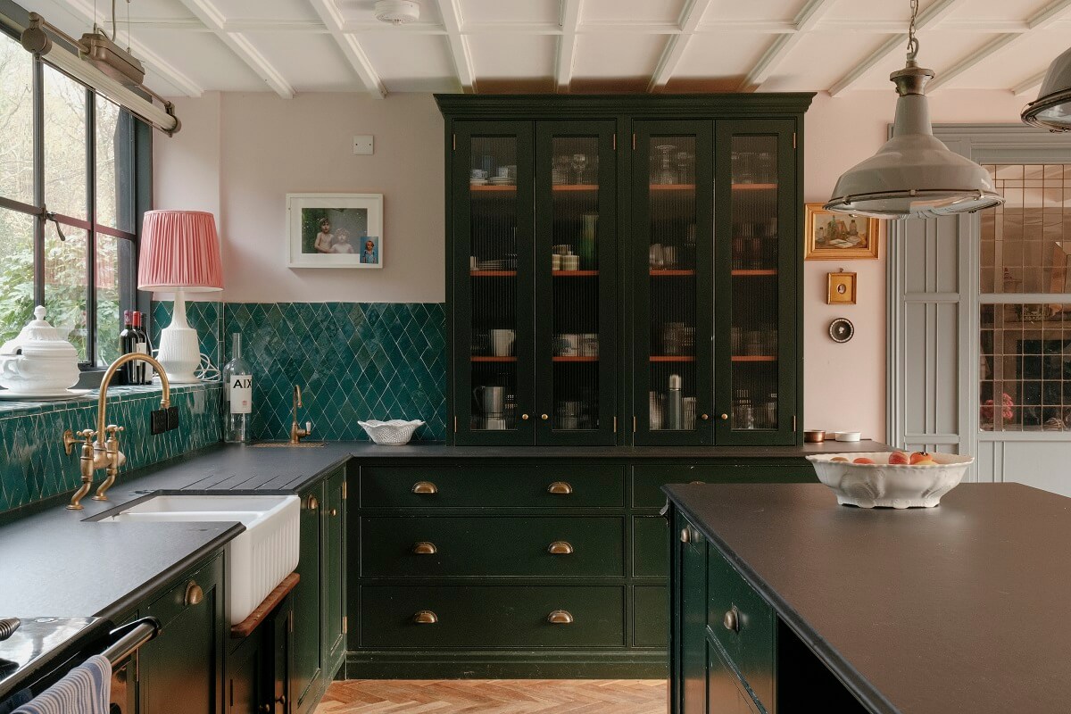 A Barn House with Vintage Decor and Exposed Beams 11 dark green devol kitchen with glass cabinets and glossy green backsplash tiles
