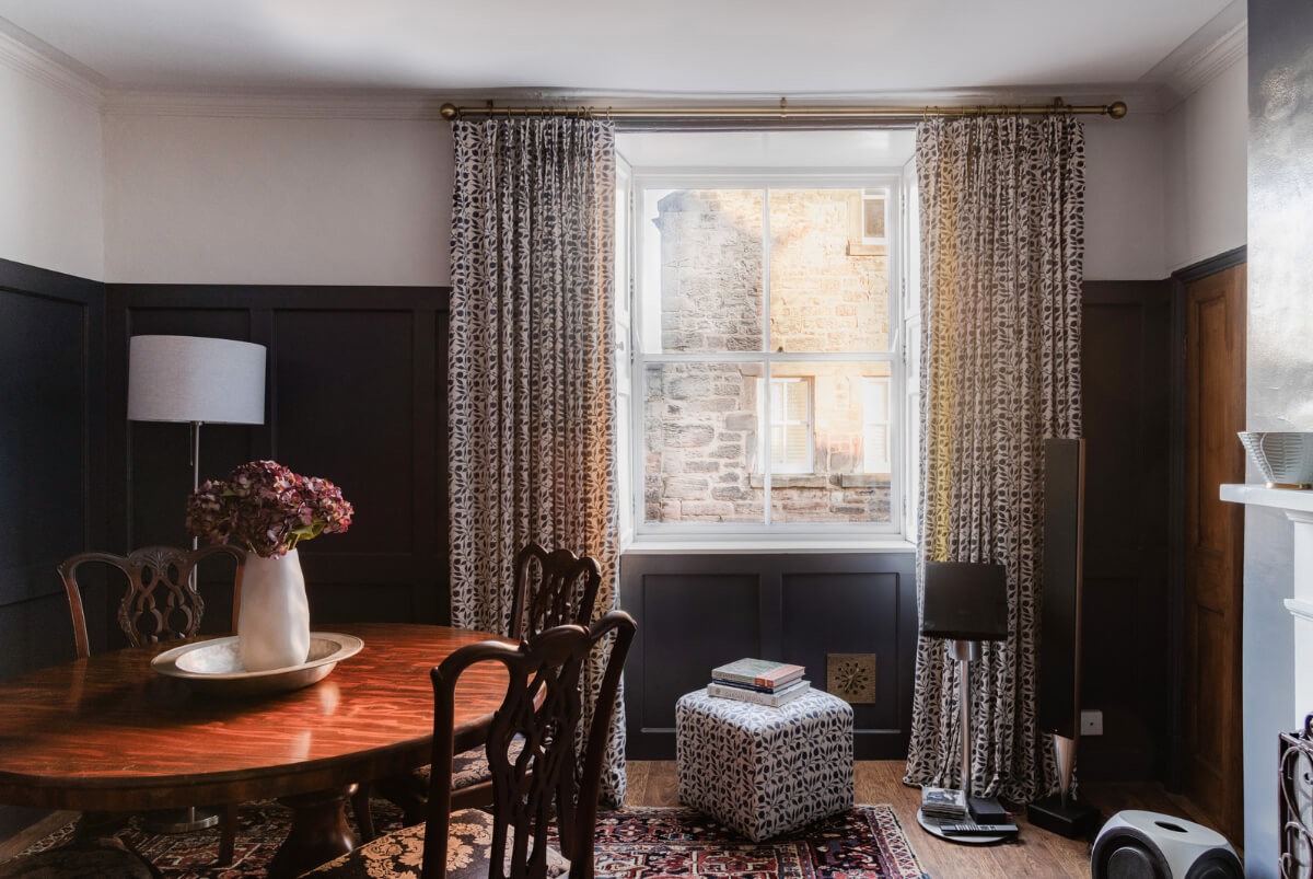 A Georgian English House Restored To Its Former Glory 2 dining room dark blue paneling round wooden table