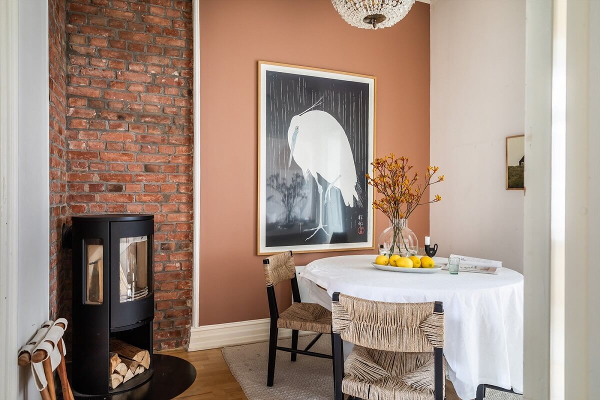Pantone Color of the Year 2025: Mocha Mousse Interior Inspiration 16 dining-room-exposed-brick-wall-fireplace-earthy-brown-wall-nordroom