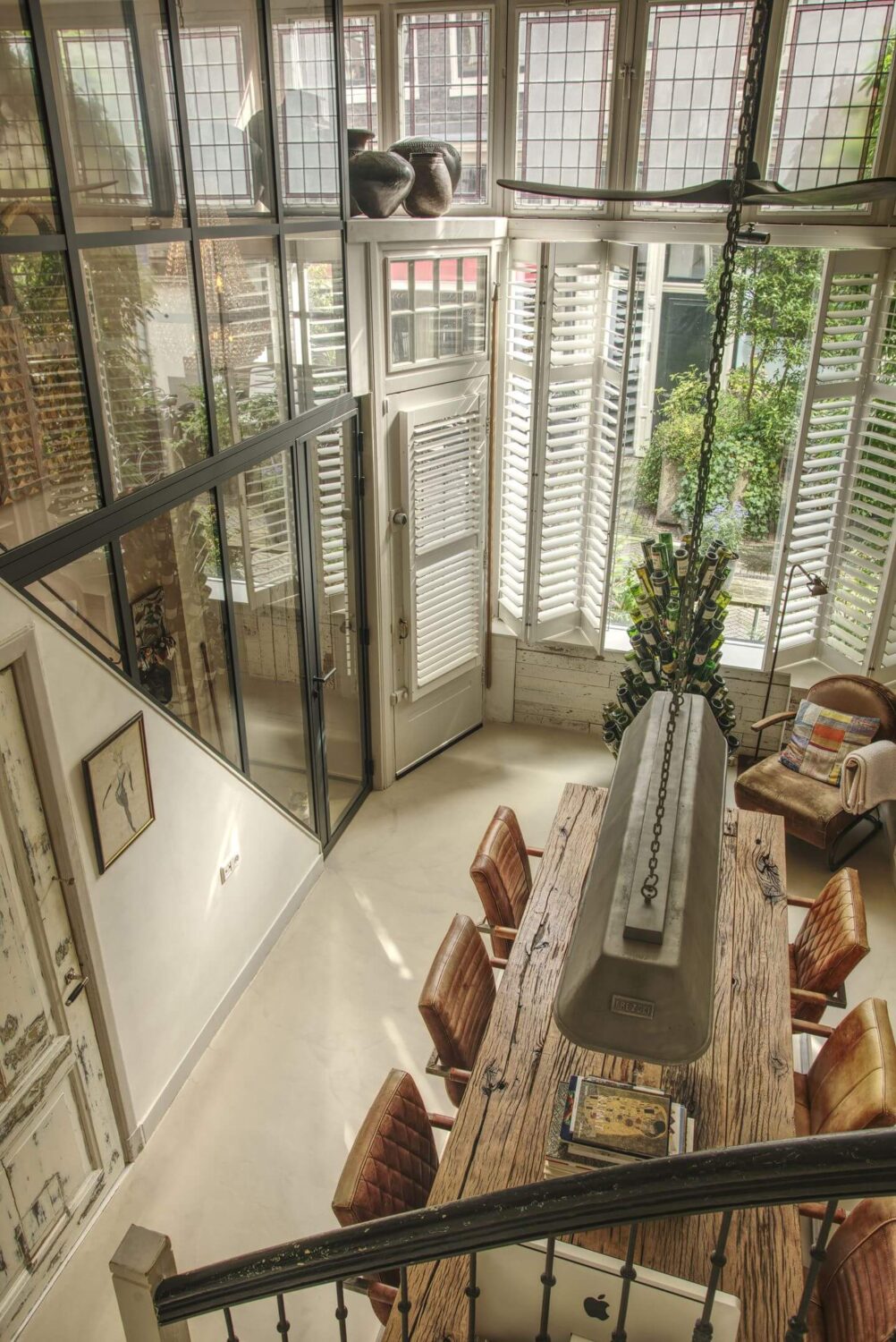 A Charming Amsterdam Townhouse with a Cozy Roof Terrace 3 dining room high ceilings stained glass windows