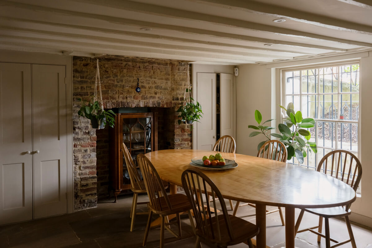 A Classic Georgian House in London with a Lush Garden 9 dining room low ceiling brick wall fireplace