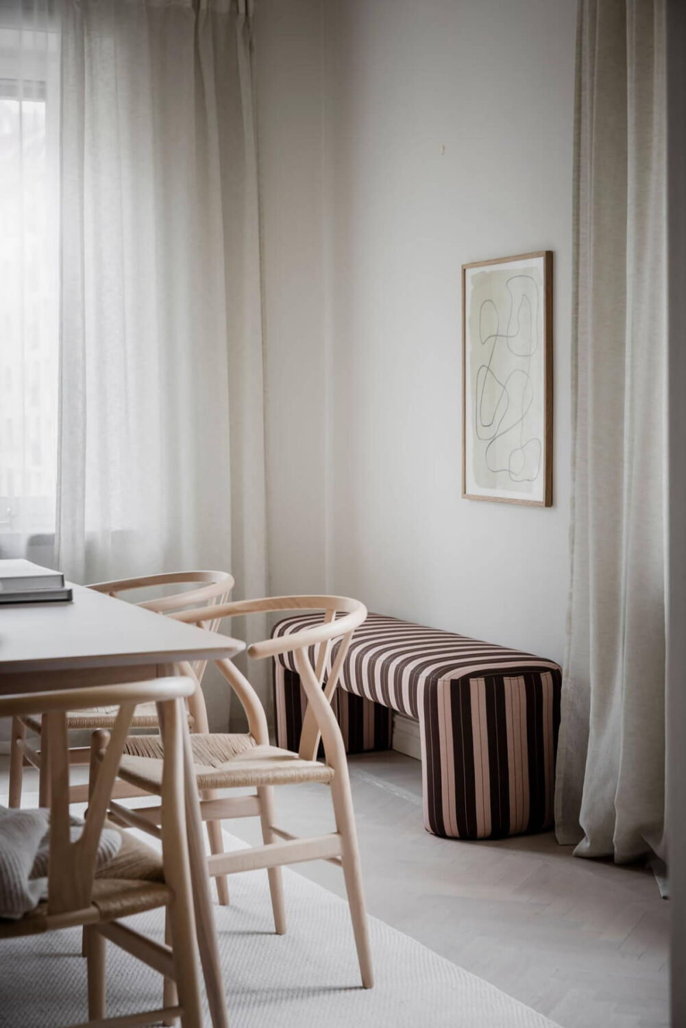 A Light Corner Apartment with an Open Flowing Floor Plan 24 dining room striped bench