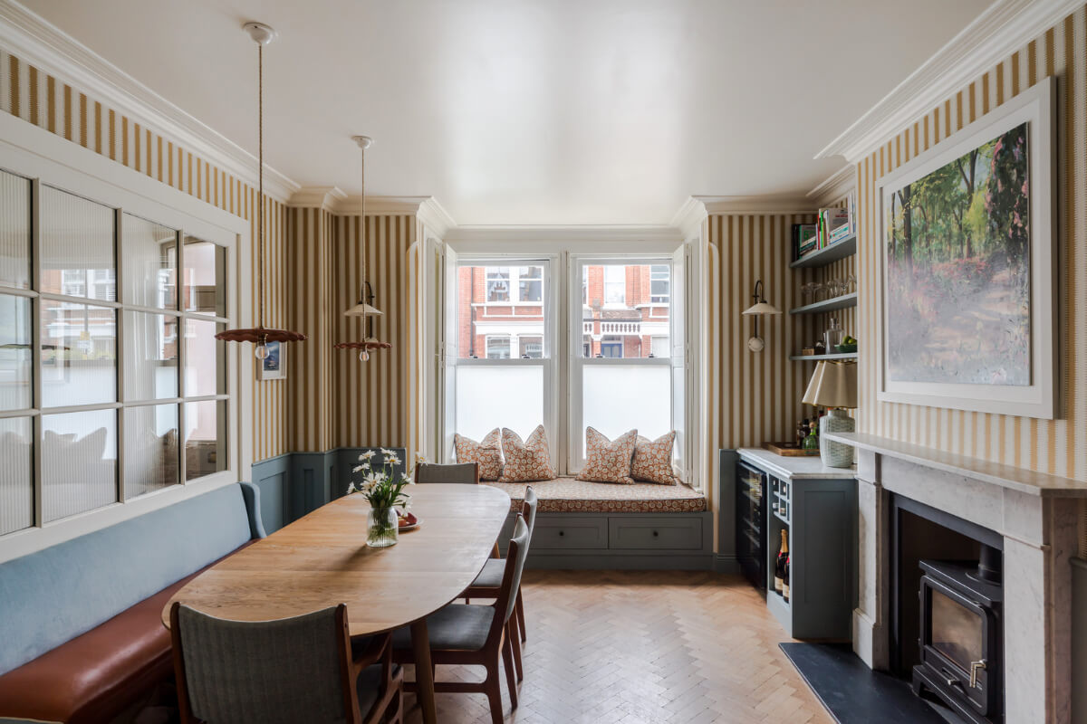 dining room striped wallpaper window seat fireplace