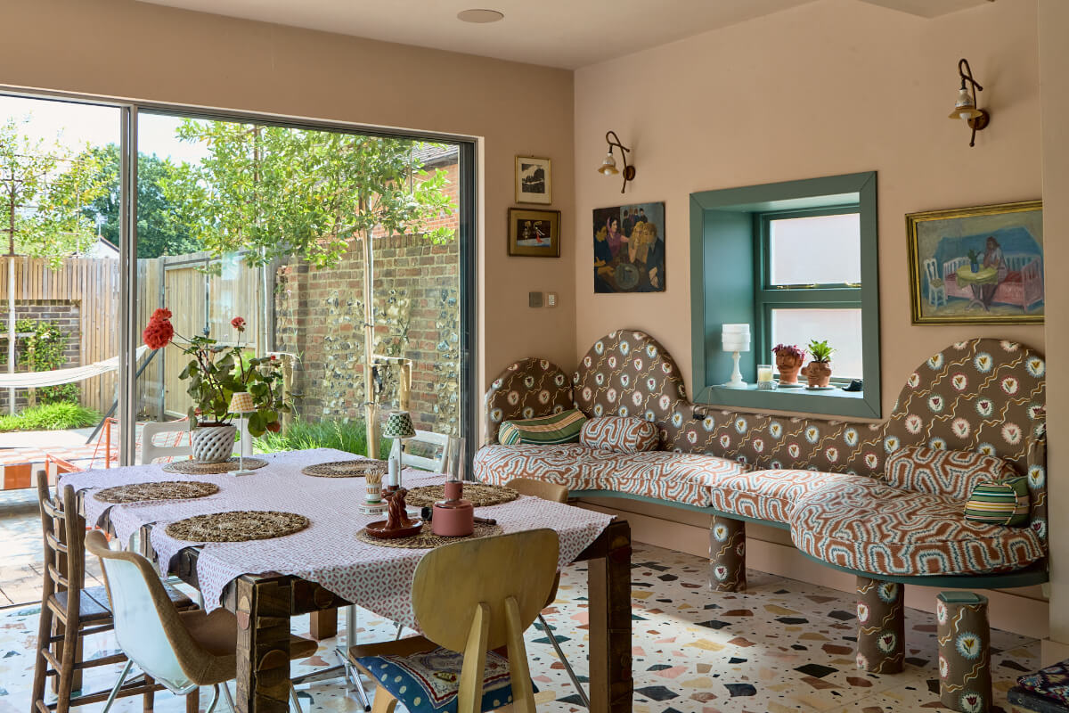 A Colorful Design-Led Georgian House in the Heart of Henley-on-Thames 5 dining space with curved built-in bench
