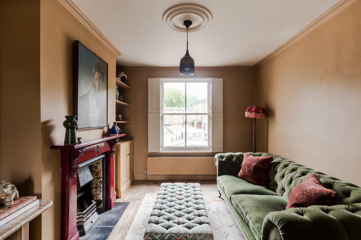 A Victorian Home with a Rich Color Palette and a Beautiful Garden 1 earth-colored living room cherry red fireplace
