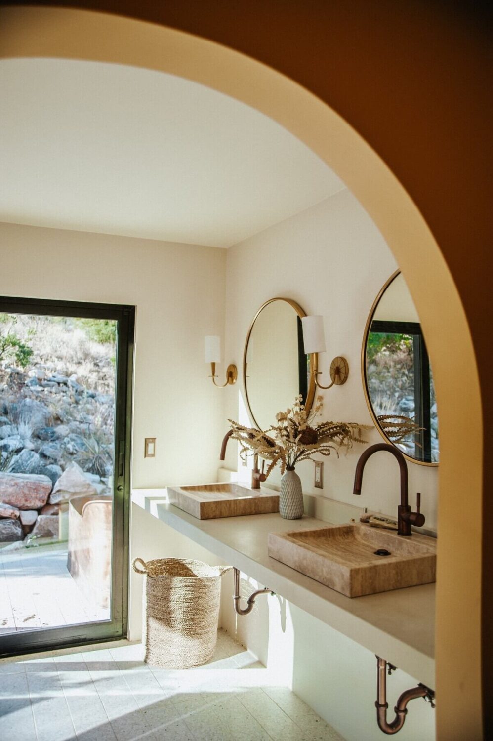 A Colorful Airbnb Home in the Morongo Valley 21 en-suite-bathroom-arched-doorway-double-sink-nordroom