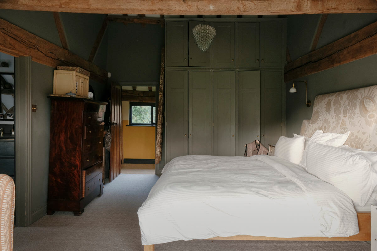 A Barn House with Vintage Decor and Exposed Beams 25 exposed beams in green bedroom