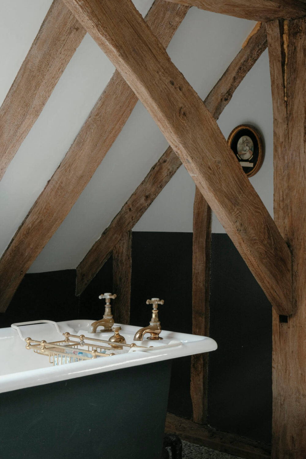 A Barn House with Vintage Decor and Exposed Beams 29 exposed wooden beams in bathroom with freestanding bath