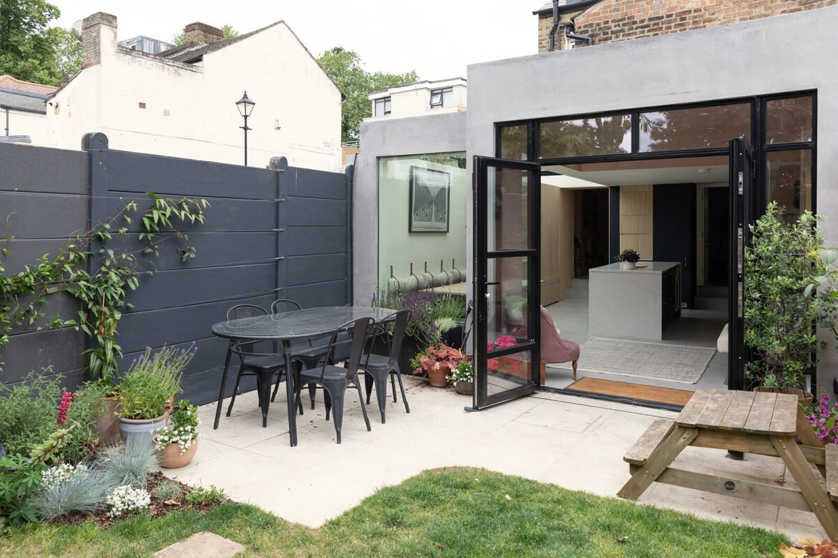 A London Family Home with a Light Modern Extension 26 garden dining table with glass doors to kitchen nordroom