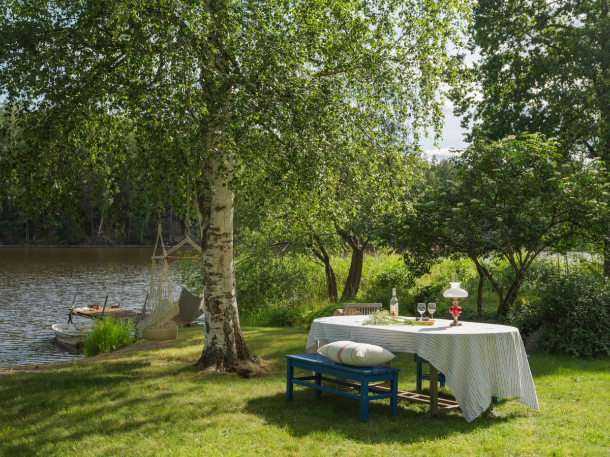 A 1930s Lakeside Country House with a Private Beach 32 garden table