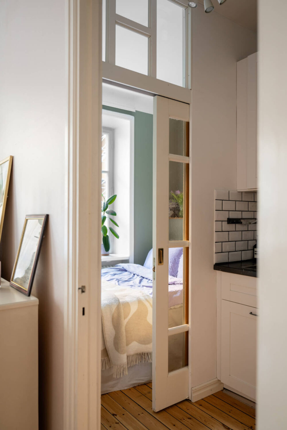 A Small Swedish Apartment with a Light Pink Living Room 13 glass sliding door bedroom